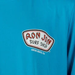 Ron Jon Kids New Performance Badge Long Sleeve Sun Shirt -Surf Edge Shop d800x800 10510136081 light blue ron jon kids new performance badge long sleeve sun shirt front graphic
